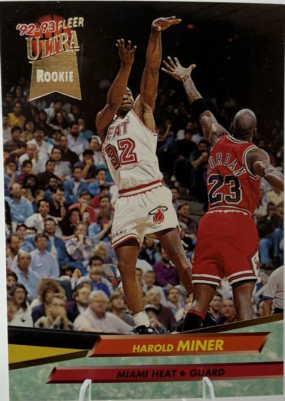 Harold Miner Miami Heat 1992-93 Fleer Ultra Rookie basketball card, with Michael Jordan of the Chicago Bulls also in the shot, in a clear plastic stand